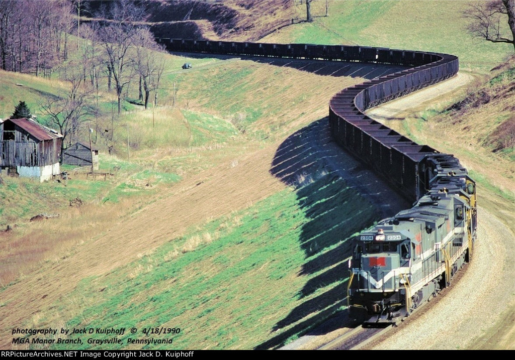 Monongahela Railway, MGA 7-23Bs 2304- 2300 leads three P&LE GP38s on the Monongahela Railways Manor Branch at, Graysville, Pennsylvania. April 18, 1990.  